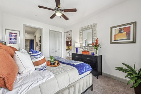 Cozy bedroom with a ceiling fan and contemporary decor at Allusion at West University apartments in Houston, TX